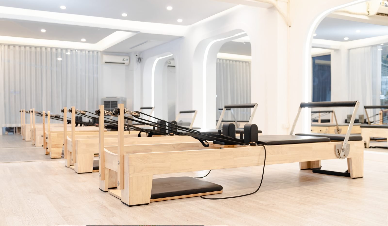 Bright minimal studio with wooden reformers